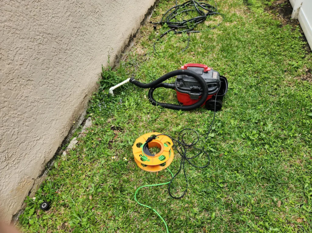 Air conditioner drain pipe cleaning outdoors
